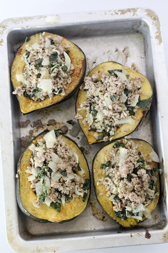 Preparing a tray of Rosemary Pork, Kale and Brown Rice Stuffed Acorn Squash
